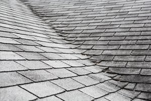 Old worn out shingles on a residential roof